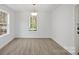 Simple dining area with hardwood floors and a light fixture at 815 Sherwood Ave, Albemarle, NC 28001