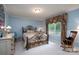 Bright bedroom with a window offering a view of the woods at 825 W Ketchie St, China Grove, NC 28023