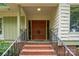 Brick steps lead to a double-door entry with ornate detailing and metal railings at 825 W Ketchie St, China Grove, NC 28023