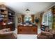 Bright home office with large windows, built-in bookcases, and a spacious desk at 825 W Ketchie St, China Grove, NC 28023