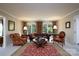 Spacious living room with large windows, leather furniture, and a red rug at 825 W Ketchie St, China Grove, NC 28023