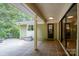 Spacious patio with tiled flooring, offering serene views of surrounding trees at 825 W Ketchie St, China Grove, NC 28023