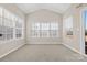 Sun-drenched sunroom with multiple windows and carpet at 9113 Rowe Ct, Charlotte, NC 28278