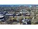 Aerial view showcasing lakefront town with shops and a church at 921 Northeast Dr, Davidson, NC 28036