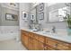 Bathroom with double vanity, light wood cabinets and a large mirror at 921 Northeast Dr, Davidson, NC 28036