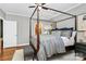 Main bedroom with four-poster bed and access to the bathroom at 921 Northeast Dr, Davidson, NC 28036