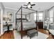 Spacious bedroom with a four-poster bed, hardwood floors, and ample natural light at 921 Northeast Dr, Davidson, NC 28036