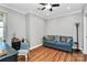 Bright home office features hardwood floors, built-in shelving and a comfortable sofa at 921 Northeast Dr, Davidson, NC 28036