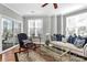 Comfortable living room with hardwood floors, large windows, and a sliding glass door to balcony at 921 Northeast Dr, Davidson, NC 28036