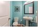 Light teal bathroom with pedestal sink and white toilet at 9408 Hamel St, Charlotte, NC 28215