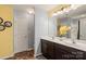 Double vanity bathroom with dark brown cabinets and yellow accents at 9408 Hamel St, Charlotte, NC 28215