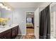 Double vanity bathroom with view into bedroom at 9408 Hamel St, Charlotte, NC 28215