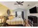 Spacious bedroom with vaulted ceiling, yellow and grey decor, and large bed at 9408 Hamel St, Charlotte, NC 28215