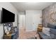 Cozy bonus room features a TV, comfortable seating, and a stylish accent wall at 9408 Hamel St, Charlotte, NC 28215