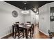 Dining area with four-chair table, hardwood floors, and dark accent ceiling at 9408 Hamel St, Charlotte, NC 28215