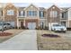 Front view of townhome community, showcasing a driveway and landscaping at 9408 Hamel St, Charlotte, NC 28215