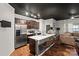 Kitchen with stainless steel appliances, dark cabinetry and breakfast bar seating at 9408 Hamel St, Charlotte, NC 28215
