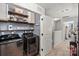 Laundry room with washer, dryer, and storage shelves at 9408 Hamel St, Charlotte, NC 28215