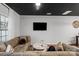 Spacious living room with large TV, comfortable seating and dark accent ceiling at 9408 Hamel St, Charlotte, NC 28215