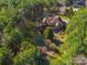 Overhead view of a stately home nestled among mature trees, showcasing a private and serene setting with well-maintained grounds at 1024 Adkins Rd, York, SC 29745