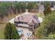 Aerial view of a brick home showcasing the pool, lush landscaping, and a long driveway leading to a serene, private property at 1024 Adkins Rd, York, SC 29745
