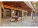 Covered patio with a wood ceiling, stone floor, tv and a dining table with six chairs at 1024 Adkins Rd, York, SC 29745