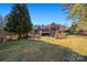 Beautiful backyard featuring a manicured lawn, mature trees, and outdoor seating with a pool, perfect for outdoor entertaining at 1024 Adkins Rd, York, SC 29745