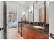 Bathroom with double vanities, granite countertops, decorative mirrors, and hardwood cabinets at 1024 Adkins Rd, York, SC 29745
