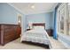 Cozy bedroom featuring a comfortable bed, dresser, and bright window with decorative curtains at 1024 Adkins Rd, York, SC 29745