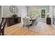 Bright dining room featuring hardwood floors, a chandelier, and large windows offering views of the surrounding landscape at 1024 Adkins Rd, York, SC 29745