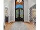 Grand foyer featuring a decorative glass-paneled door, hardwood floors, and an arched doorway at 1024 Adkins Rd, York, SC 29745