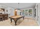 Bright game room features a pool table and large windows overlooking the outdoor patio at 1024 Adkins Rd, York, SC 29745