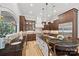 Spacious kitchen featuring dark wood cabinets, granite countertops, pendant lighting, and stainless-steel appliances at 1024 Adkins Rd, York, SC 29745