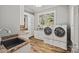 Bright laundry room with granite countertops, built-in cabinets, and modern washer and dryer at 1024 Adkins Rd, York, SC 29745