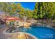 Beautiful swimming pool with a sun umbrella and a lovely wooded perimeter providing shade and privacy at 1024 Adkins Rd, York, SC 29745
