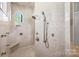Beautiful tiled shower with rainfall shower head, handheld sprayer, and built-in bench at 1024 Adkins Rd, York, SC 29745