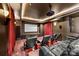 Home theater boasts tiered seating, a projector screen, and a comfortable leather sofa at 1024 Adkins Rd, York, SC 29745