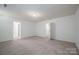 Large bedroom with access to two other rooms and neutral carpeting at 120 Fern Ln, Troutman, NC 28166