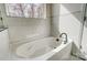Relaxing soaking tub with a view from the window in this bright white bathroom at 122 Stockbridge Ln, Statesville, NC 28625