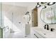 Bright bathroom with double vanity, modern mirrors and fixtures, and marble style floor at 122 Stockbridge Ln, Statesville, NC 28625