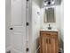 Contemporary bathroom featuring a stylish vanity with wood cabinets and modern lighting fixtures at 122 Stockbridge Ln, Statesville, NC 28625