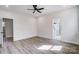 Spacious bedroom with dark ceiling fan, light hard wood floors, and neutral paint at 122 Stockbridge Ln, Statesville, NC 28625