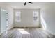 Sunlit bedroom with two windows with hardwood floors and neutral walls at 122 Stockbridge Ln, Statesville, NC 28625