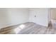 Empty bedroom featuring wood-look floors, a closet door, and white trim at 122 Stockbridge Ln, Statesville, NC 28625