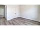 Bright bedroom with double door closet, wood-look floors, and white trim at 122 Stockbridge Ln, Statesville, NC 28625