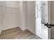 Walk-in closet with wire shelving and wood-look floors near a bathroom at 122 Stockbridge Ln, Statesville, NC 28625
