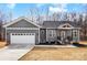 Charming single-Gathering home features a gray exterior, attached garage, and inviting front porch at 122 Stockbridge Ln, Statesville, NC 28625