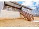 Back view of a home with gray siding, wooden stairs, and a spacious lawn at 122 Stockbridge Ln, Statesville, NC 28625