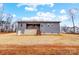 Charming home with gray siding, a back porch, wooden stairs, and a spacious, sunny yard at 122 Stockbridge Ln, Statesville, NC 28625