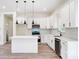 Stylish kitchen featuring white cabinetry, sleek countertops, and stainless steel appliances at 122 Stockbridge Ln, Statesville, NC 28625